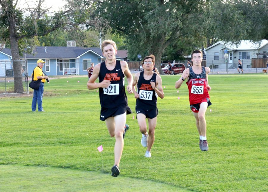 Newell Berry, senior, leads a pack of runners with his team mate, Warren Watson, junior, close behind. 