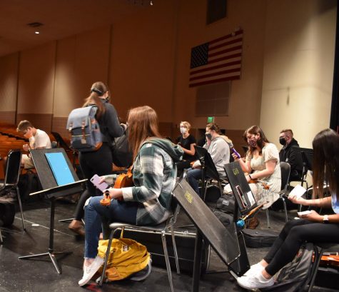 Orchestra students practice on stage for the upcoming preview concert.