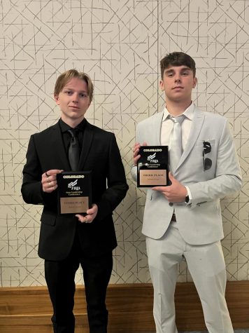 GJHS senior Dean Withers, left, and sophomore Taytin Knoblich hold the awards they received at the state FBLA competition.