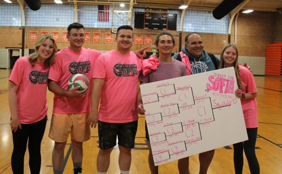 Senior Annie Feather and junior Macy McComb pose for a photo with the winning team from the tournament