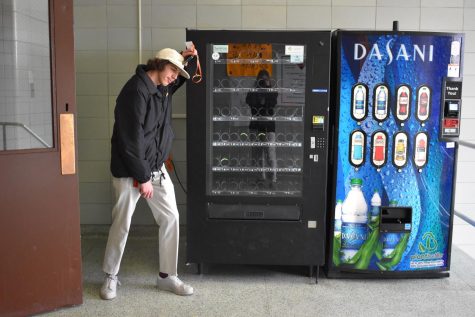 Jacob Feller leaning on the empty vending machines