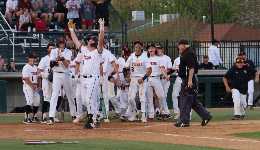 Cameron Ochoa and his teammates celebrate his home run