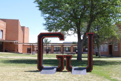 Grand Junction High School 2023 graduates get the chance to take photos on the front lawn of the school with the large GJ sign they will walk through at the graduation ceremony. The photo opportunity is a tradition for GJHS.