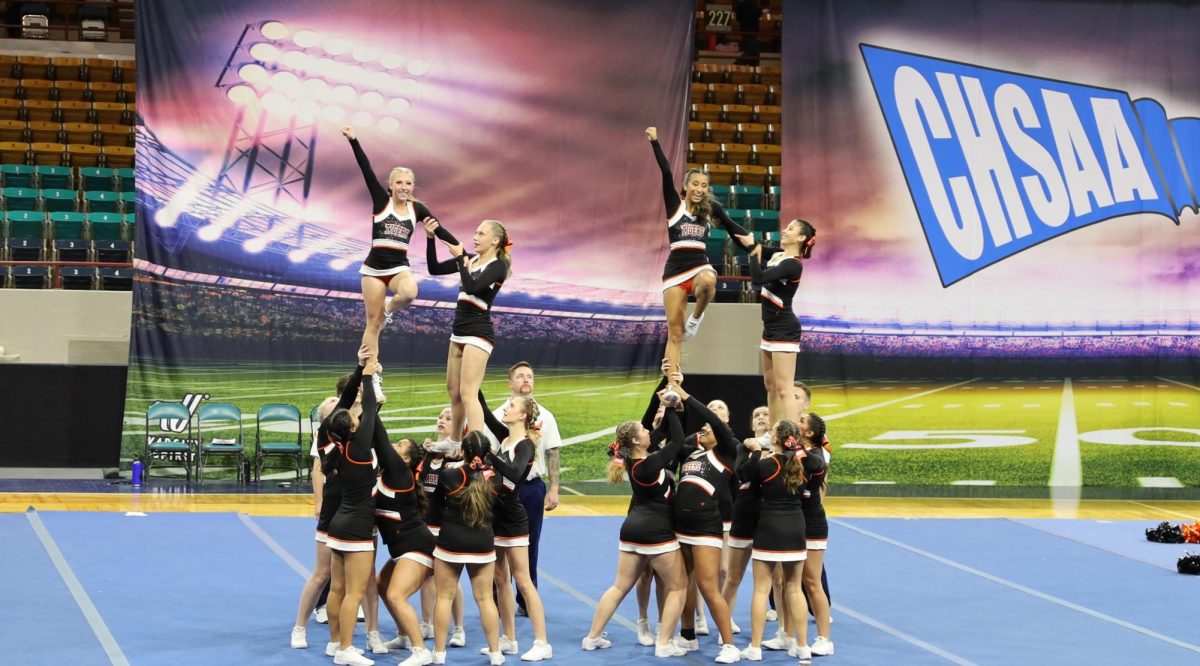 GJHS Cheer throws a stunt on the state mat during class 4A competition.