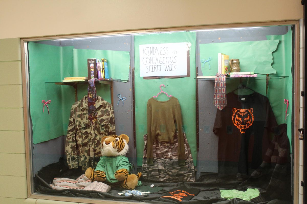 There is a Kindness is Contagious week display next to the Tiger Boutique & Haberdashery. 