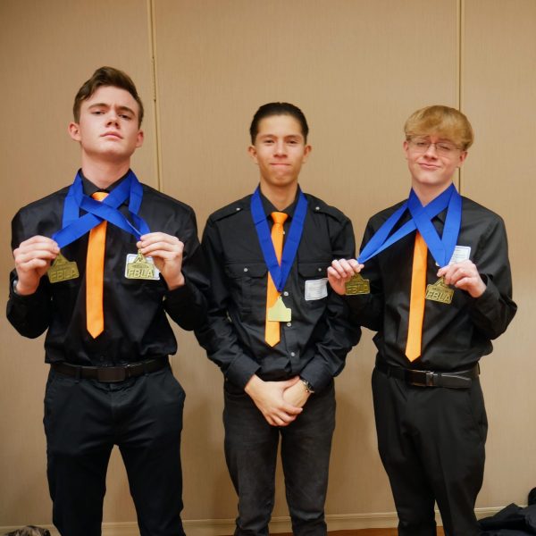 FBLA members junior Alex Kirch, junior Jess Strickland, and freshman Gabriel Gonzalez show off their second place medals from the district competition. GJHS students competed in district on January 30th at Colorado Mesa University.