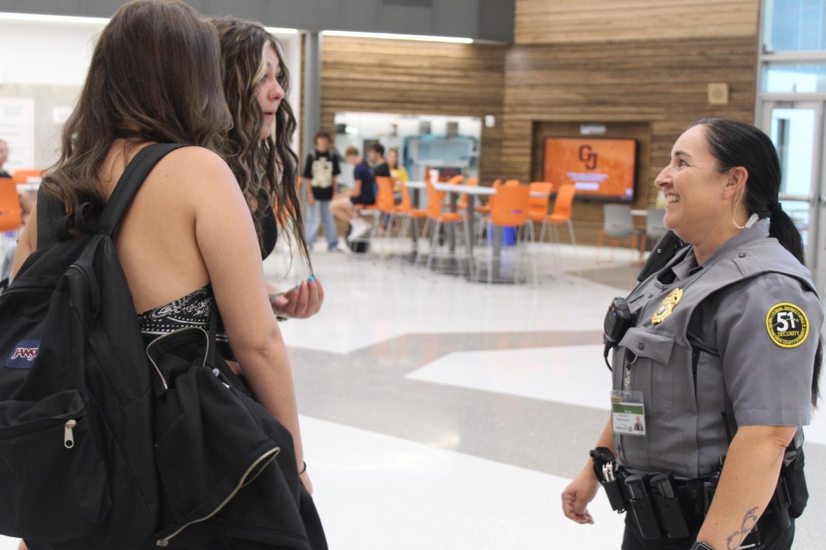 GJHS School Security Officer Penny Harris chatting with students during 5th hour. Harris, along with GJHS SROs, are often found engaging with students in the halls and commons throughout the school day.