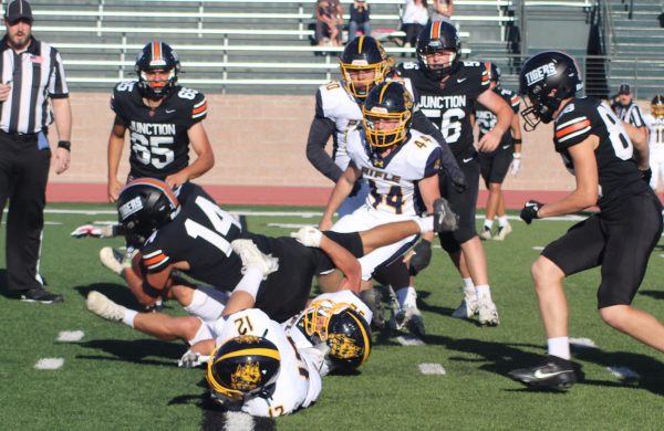 GJHS sophomore Eziah Morales dives for extra yardage during the season-opening victory over Rifle. The Tigers dominated on offense and defense in the 48-0 victory.