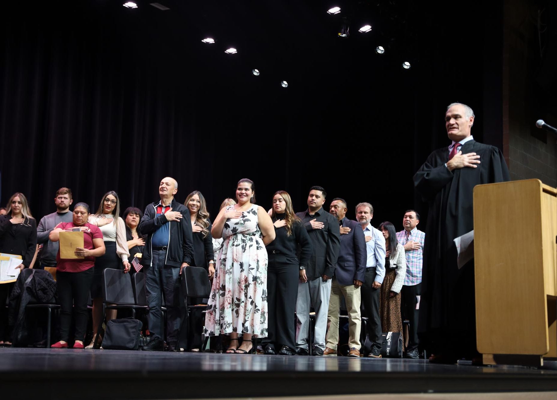 New American citizens recite the Pledge of Allegiance for the first time. Juniors and seniors at GJHS had the opportunity to watch their naturalization ceremony in the GJHS auditorium.