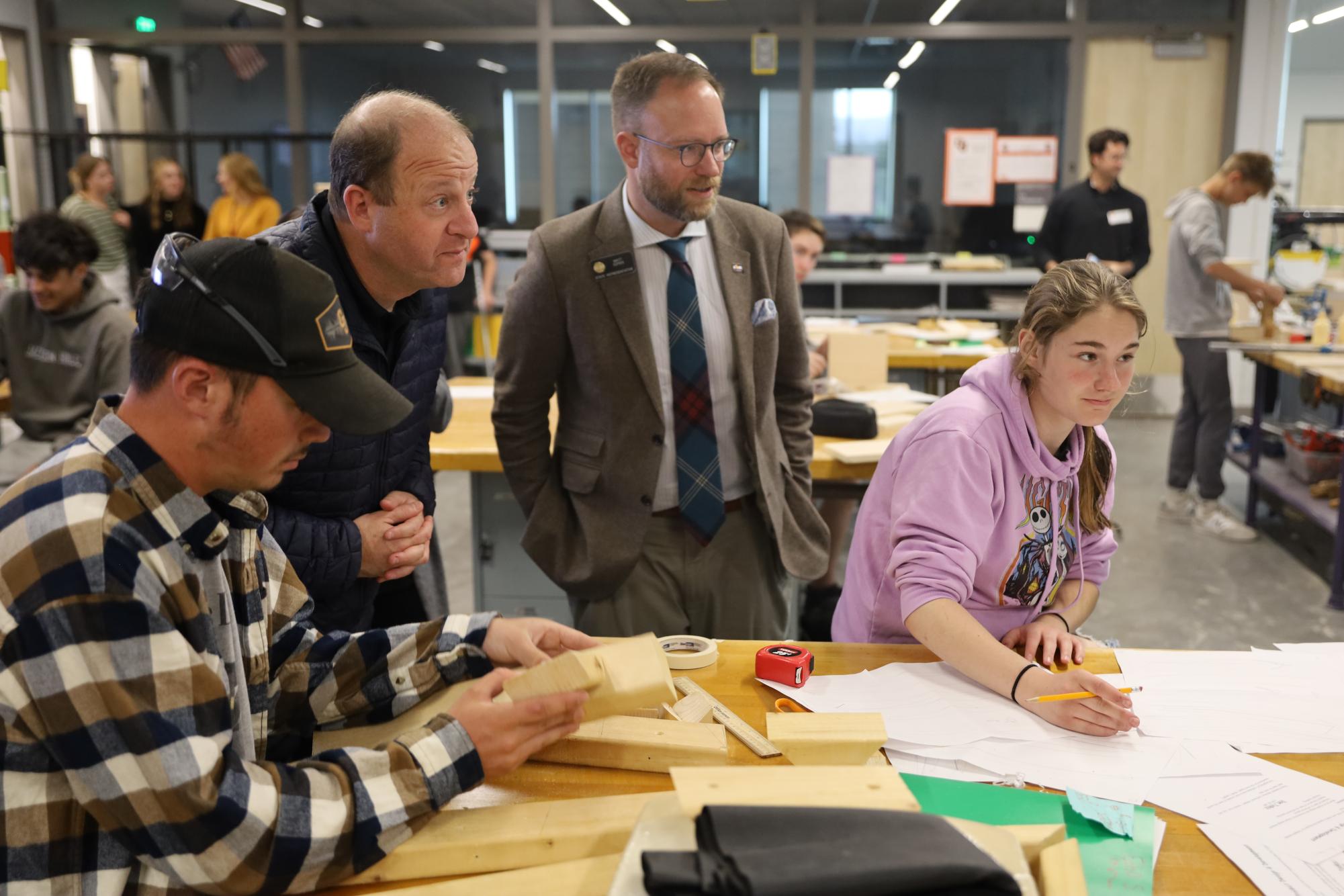 Gov. Jared Polis (D-Boulder) and state Rep. Matt Soper (R-Delta) interact with students in the woodworking classroom at GJHS, asking about their individual projects. Polis spent 45 minutes at the new school and visited multiple programs. 