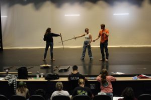 Theater director Bryan Carlson and students rehearsing a fight scene after school in the new GJHS auditorium.