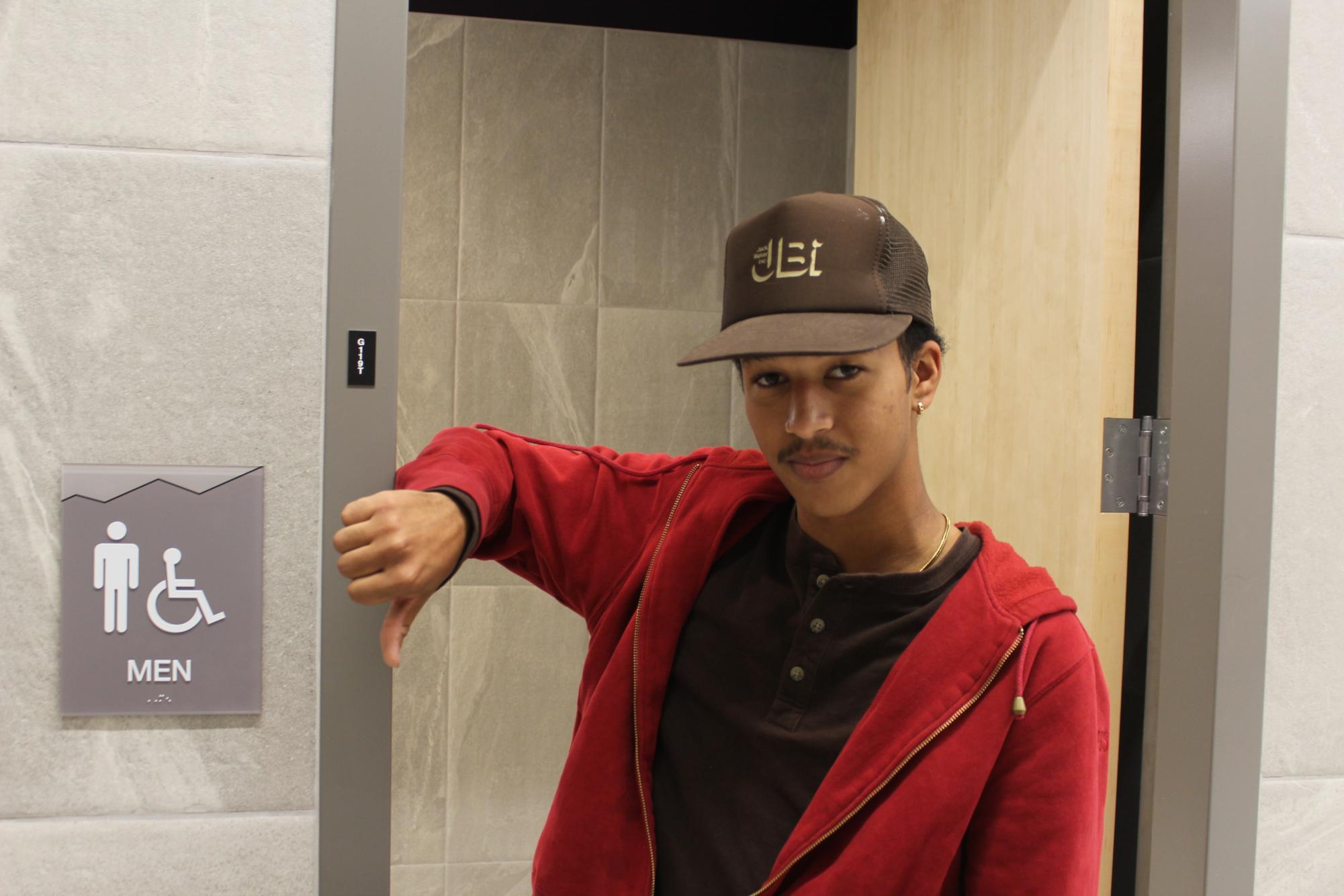 Grand Junction High School senior Desmond Danso poses to show what he thinks of the bathroom policy. He gives it a thumb's down.