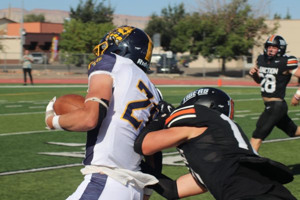 GJHS football player tackles a Rifle High School player. The football team will be playing in playoffs this Sunday, Nov. 10 at 1 p.m. in Stocker Stadium (moved from Nov. 9 to 10)