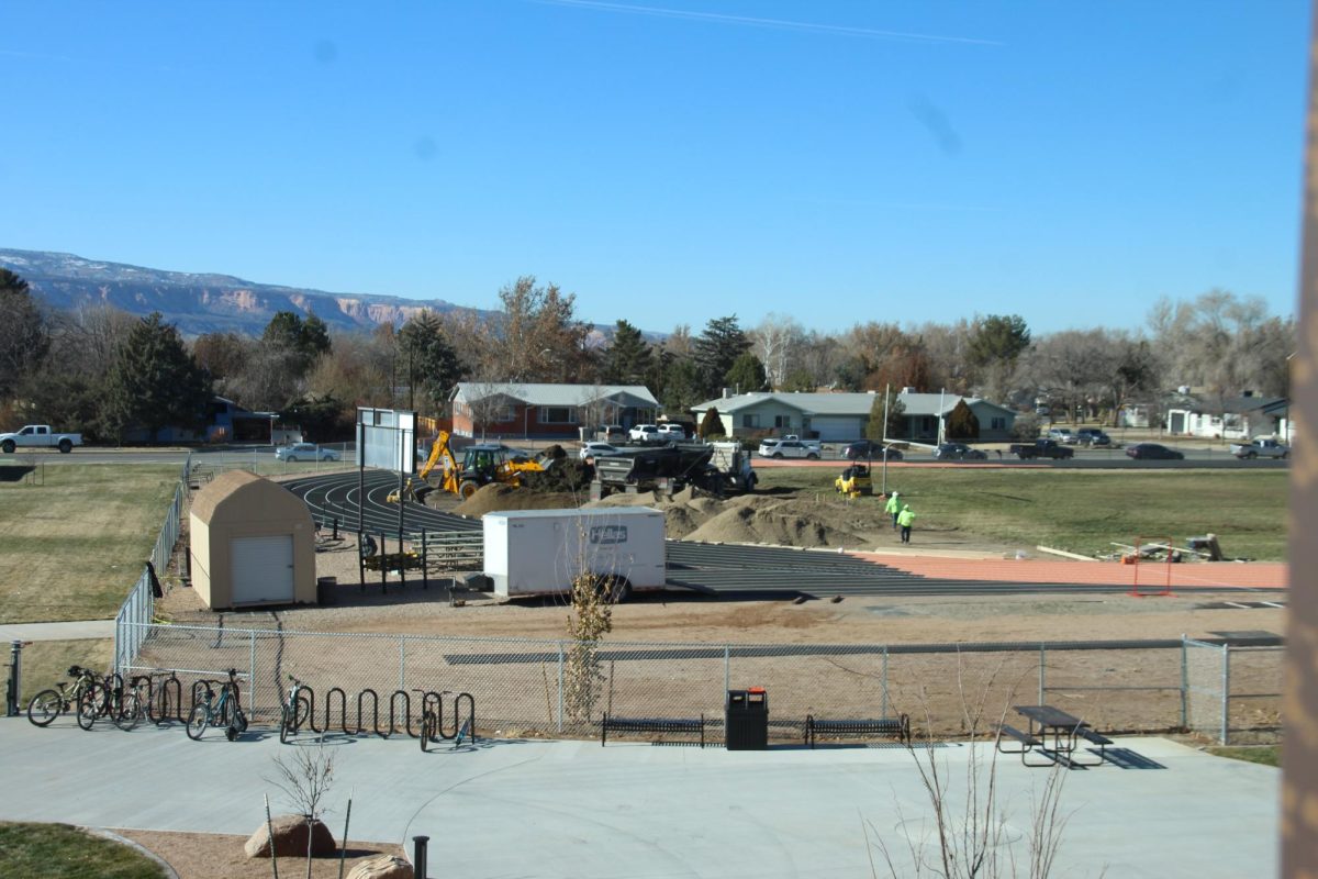  This is a photo of the field as construction began. The south end is visible here with a large pile of torn-up dirt, construction vehicles, and workers.
