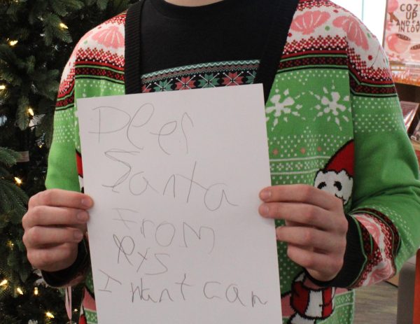 A GJHS student proudly shows off his letter to Santa. He was seen waiting by the Christmas tree in the library as the rest of the students left for the holiday break.