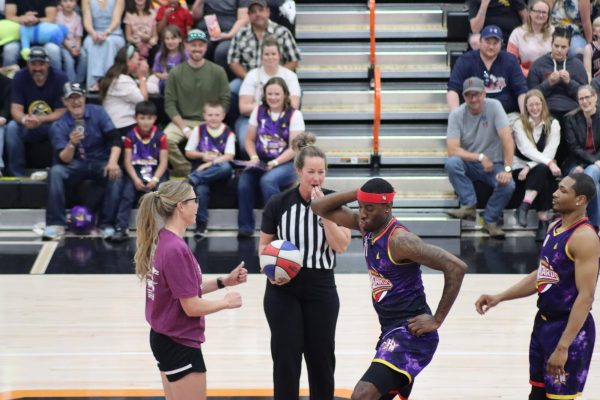 The Harlem Wizard called Dragon breaks into a dance before the tipoff at the beginning of the game. Dragon frequently would have an outburst or do something flashy to distract players and spectators.