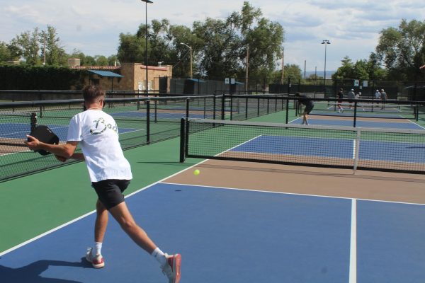 GJHS sophomore Will Simpson gets a swing in a pickleball game. The new GJHS Pickleball club plays at the Lincoln Park pickleball courts every Friday after school. 