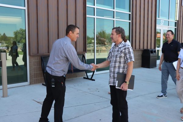 GJHS Principal Jory Sorensen and CU President Todd Saliman shake hands at the Front Entrance. The event began shortly afterwards as the participants went to the library to eat lunch.