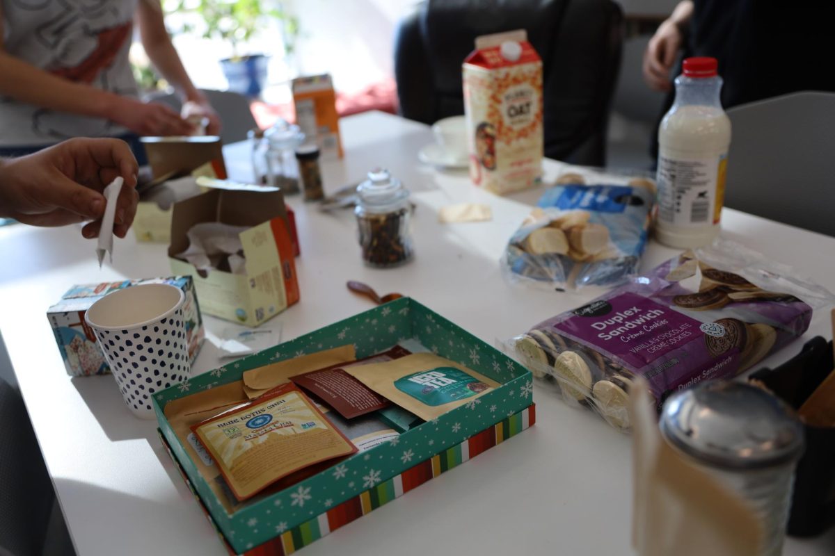 Students make tea at the tea table. Tea club offers a wide variety of teas, milks, sweeteners, and desserts.