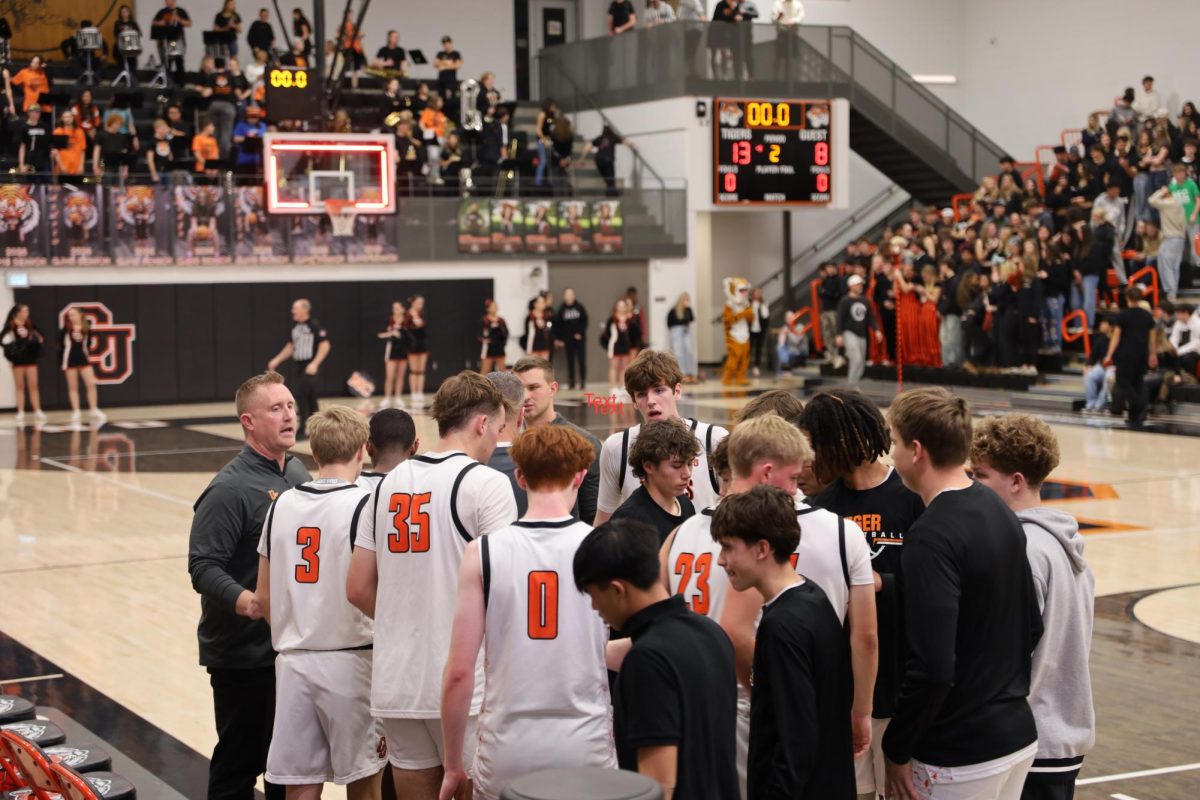 The GJHS boys' basketball team huddles up in a timeout. The team went on to defeat Central High School 54-27.