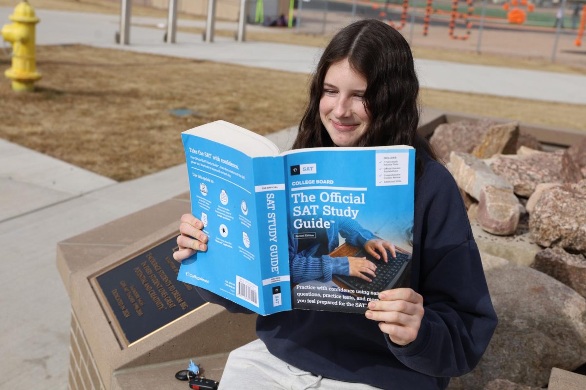 Penelope Kuehlhorn, a junior at GJHS, reading the Official SAT Study Guide. Some students use SAT prep books, take online courses, or even hire their own tutor. 