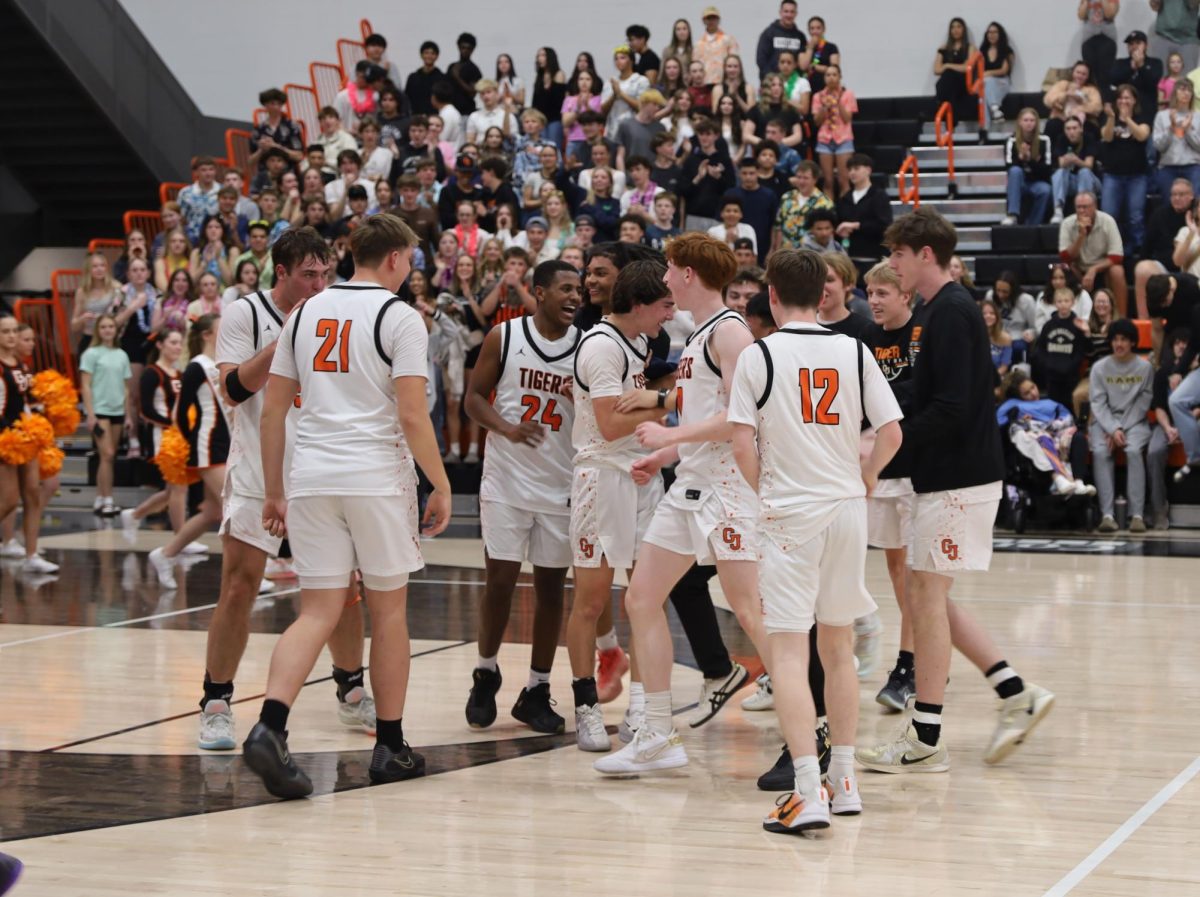 The GJHS boys' basketball team celebrates as they win their second playoff game against Golden. The final score was 54-41.