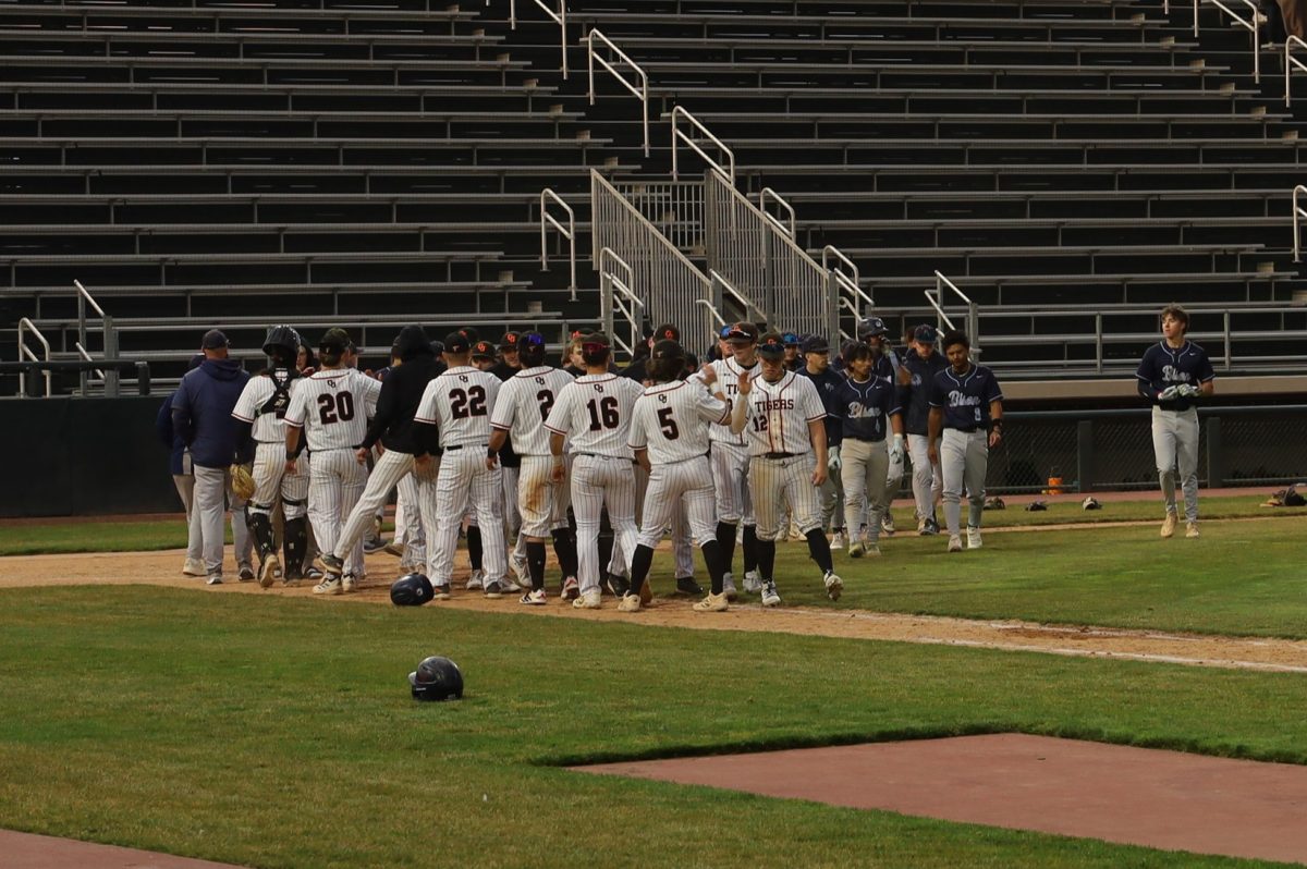 The GJHS baseball team shakes hands with the Fossil Ridge after their game on March 6. The Tigers won 16-6 for this game, their second of the season.