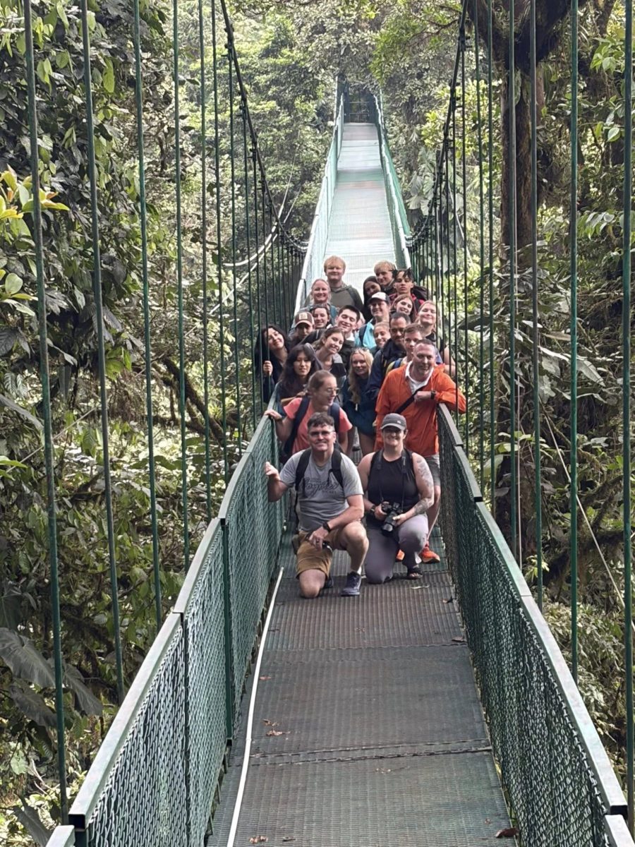 GJHS travelers pose on a bridge above the jungle canopy. The group went on a canopy tour over Monteverde Cloud Forest to see the flora and fauna.