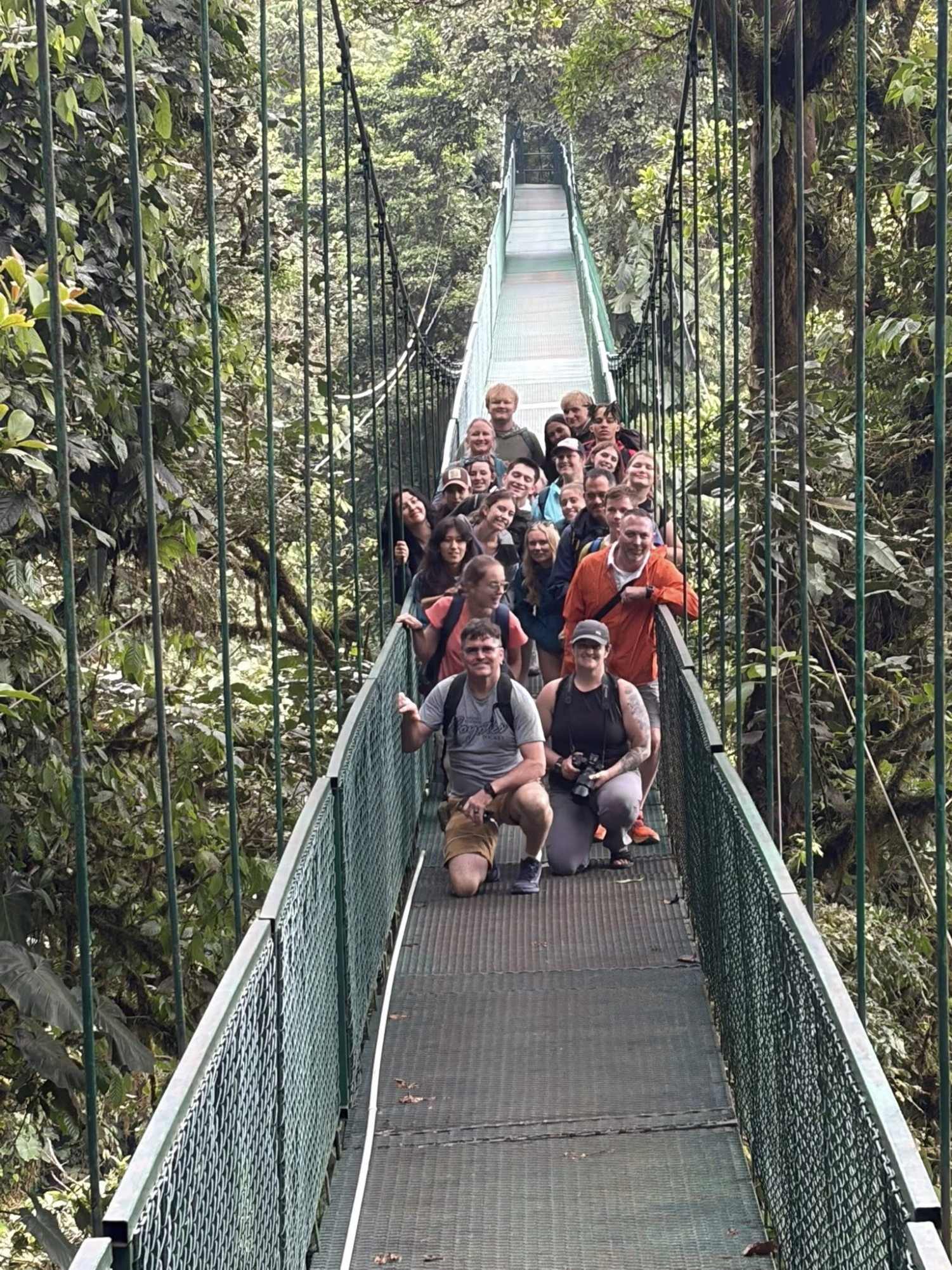 GJHS travelers pose on a bridge above the jungle canopy. The group went on a canopy tour over Monteverde Cloud Forest to see the flora and fauna.