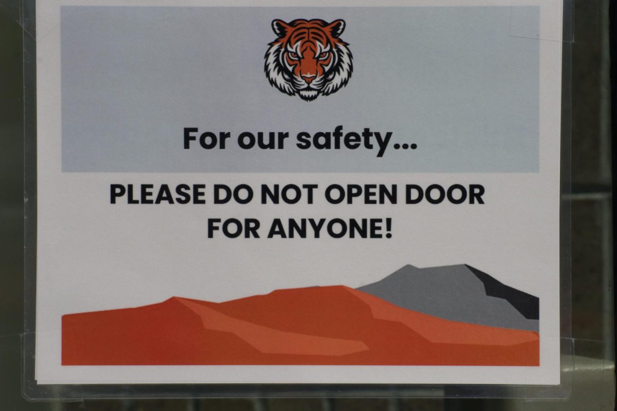 A sign located on the west wing of the building at the bottom of the staircase. The doors around GJHS are locked throughout most of the day, and students are told to only enter through the front doors.