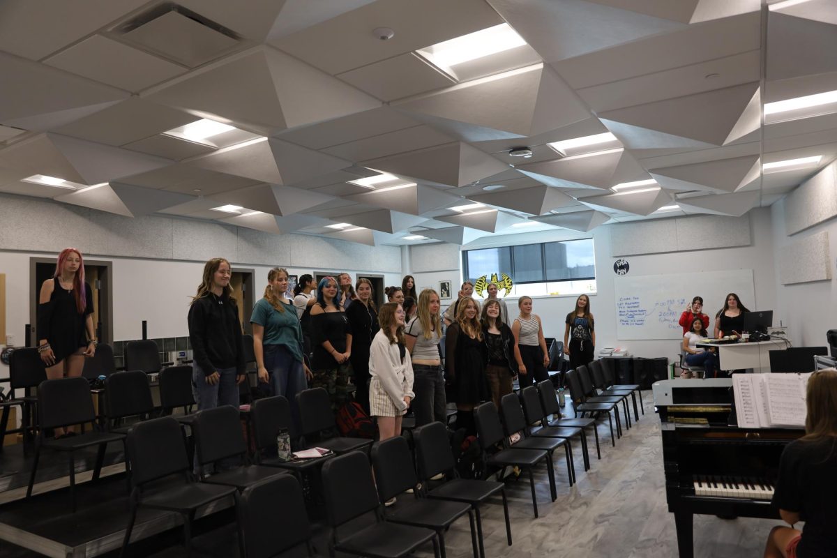 The GJHS choir room is featured with many students rehearsing. All GJHS choir programs use the room regularly.