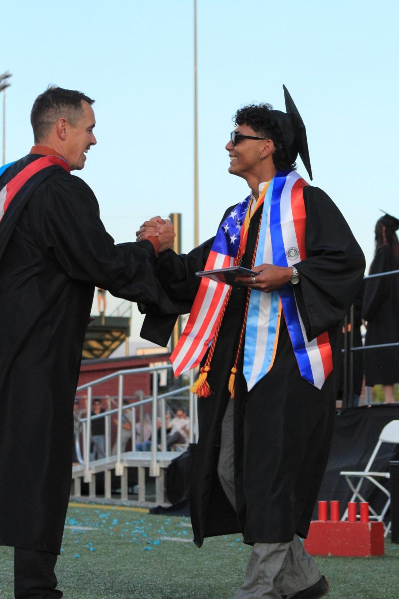 GJHS graduate Leonel Villalon shakes hands with GJHS principal Jory Sorensen after receiving his diploma.
